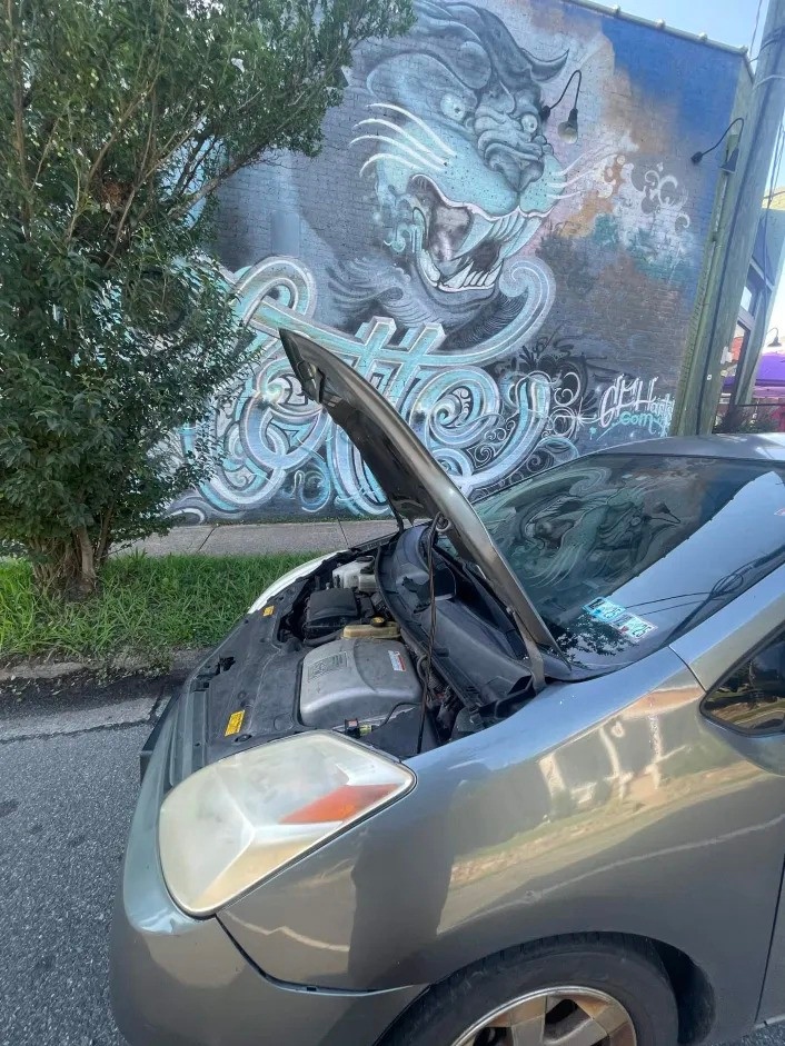 Mobile mechanic service in Charlotte NC near South Mint Street with hood open by panther mural